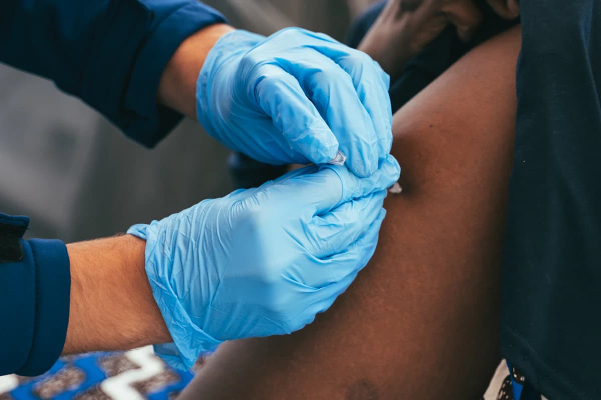 A vaccination being given in the upper arm